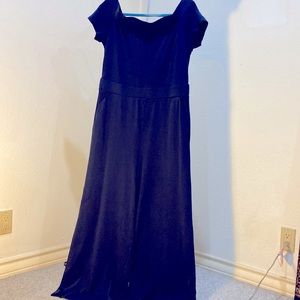 Dark blue pull on jumpsuit with wide legs and pockets at waistline